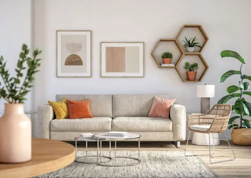A spacious living room with a huge couch inside and two paintings on the wall